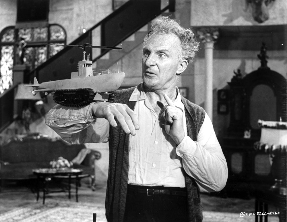 Film still of Emil Stika carrying a model ship - Photo Print