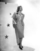 Virginia Mayo Leaning on Wall Photo Print showcasing classic Hollywood elegance.