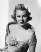 Virginia Mayo posed in dress with hand on hip photo print.
