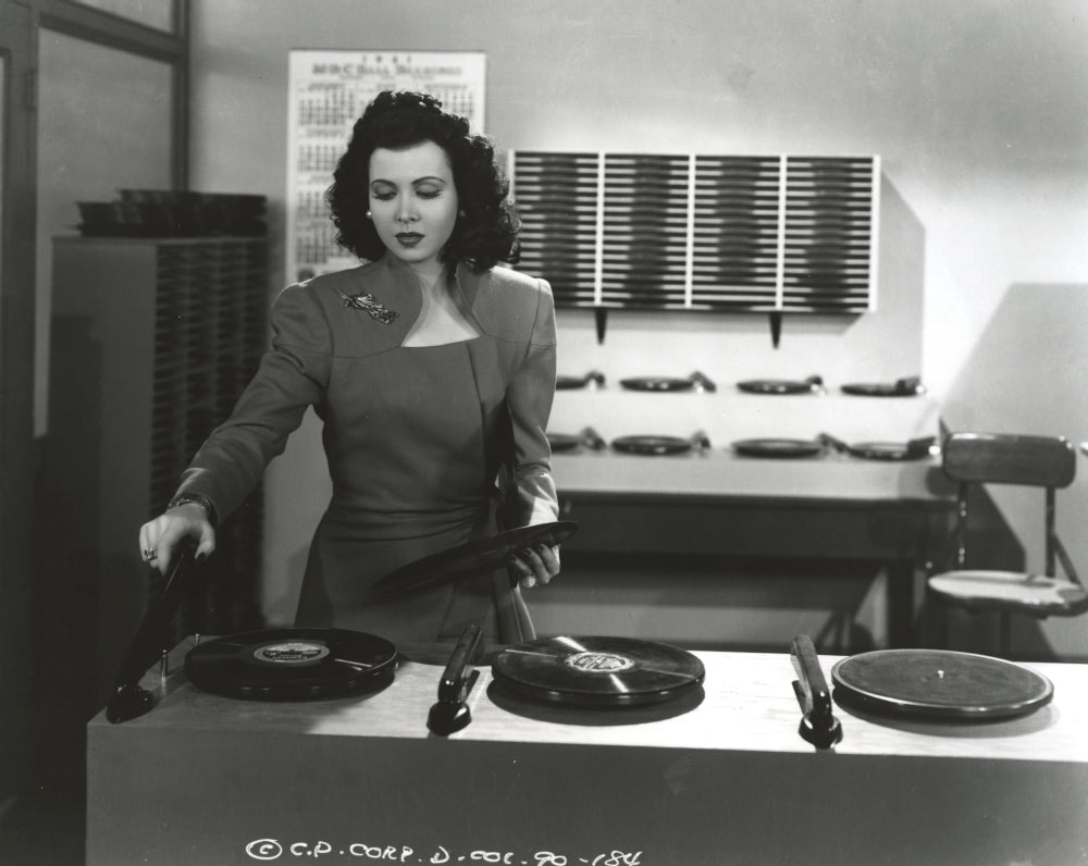 Ann Miller operating a turn table in a classic portrait photo print.