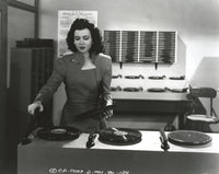 Ann Miller operating a turn table in a classic portrait photo print.