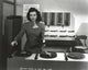 Ann Miller operating a turn table in a classic portrait photo print.
