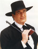 Hugh O'Brien wearing a black suit and hat holding a pistol photo print
