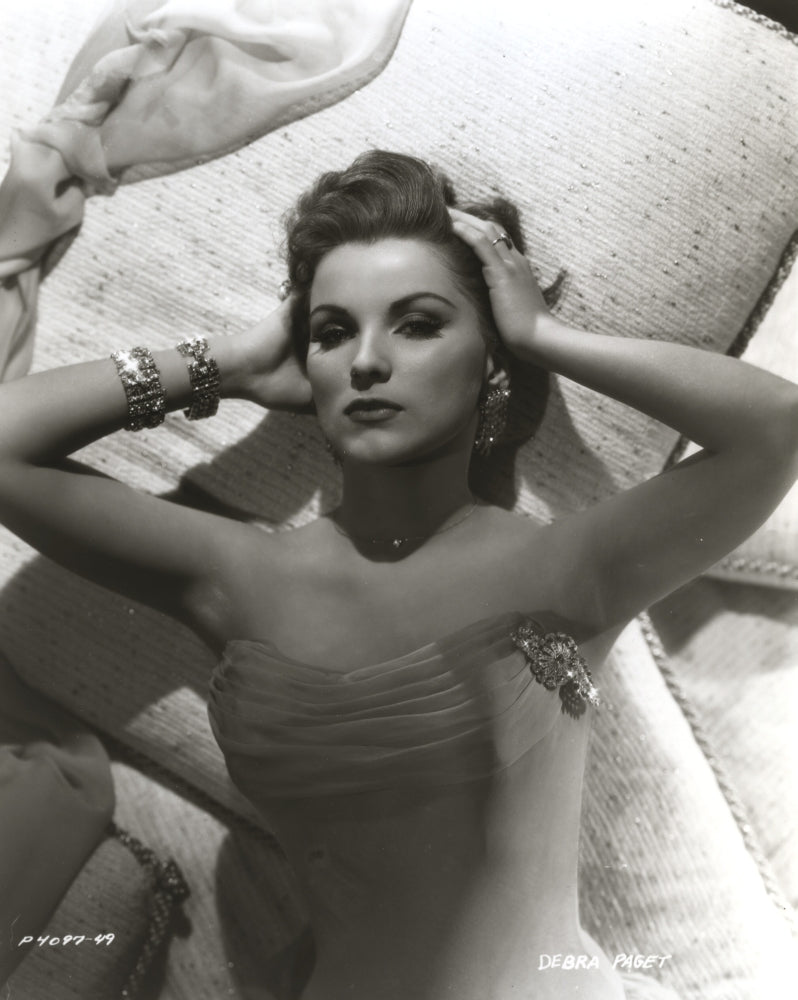 Debra Paget lying on a bed photo print showing vintage Hollywood elegance.