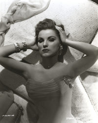 Debra Paget lying on a bed photo print showing vintage Hollywood elegance.