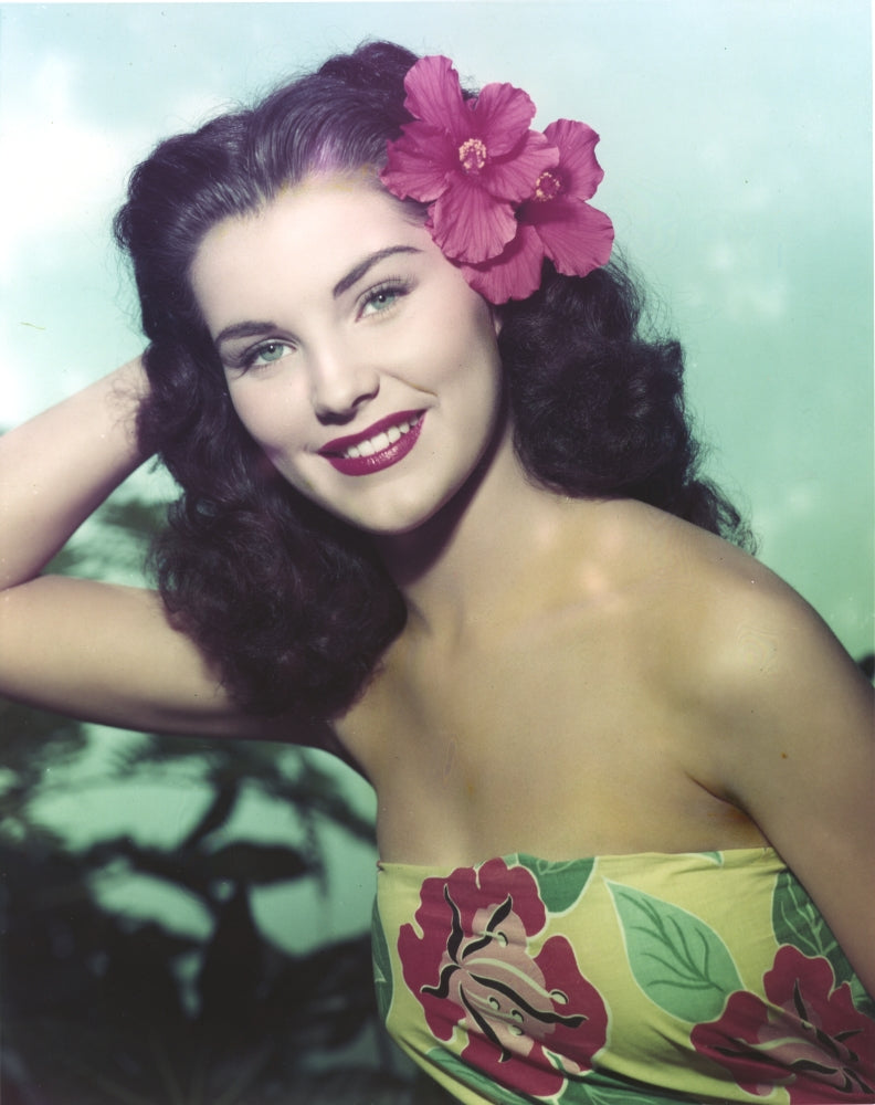 Close up portrait of Debra Paget wearing a floral dress, vintage photo print.