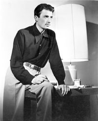 Gregory Peck sitting beside a lamp on a side table photo print.