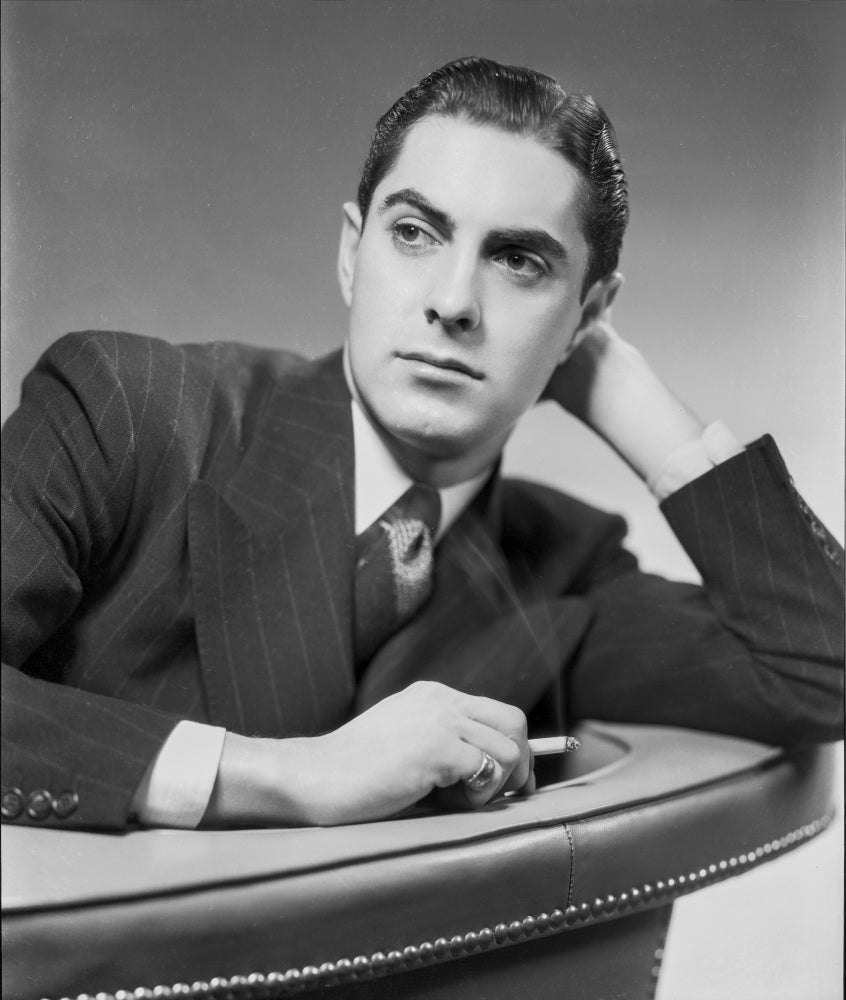 Tyrone Power leaning on a couch black and white photo print