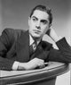 Tyrone Power leaning on a couch black and white photo print