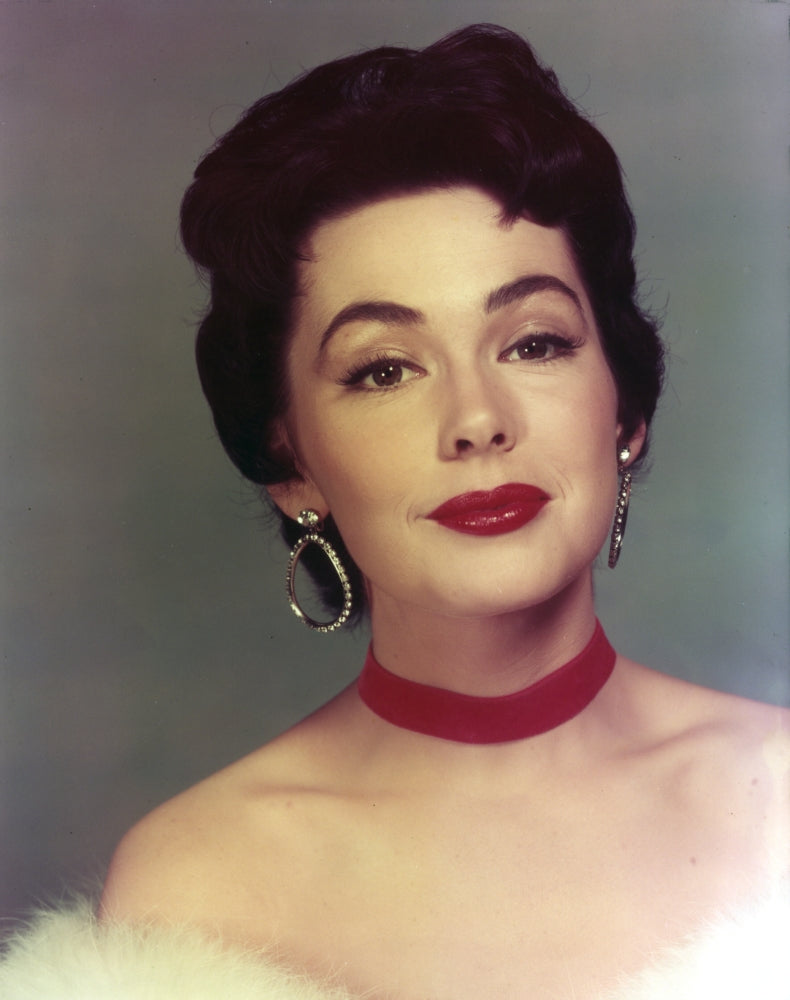 Close up portrait of Barbara Rush wearing hook earrings.