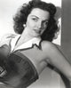 Jane Russell posed in black linen shoulder dress with white collar photo print.