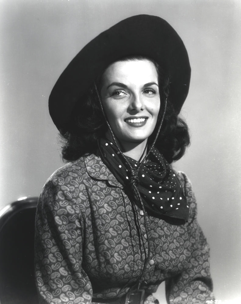 Jane Russell portrait in long sleeve shirt and cowboy hat against white background.