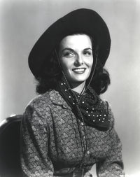 Jane Russell portrait in long sleeve shirt and cowboy hat against white background.