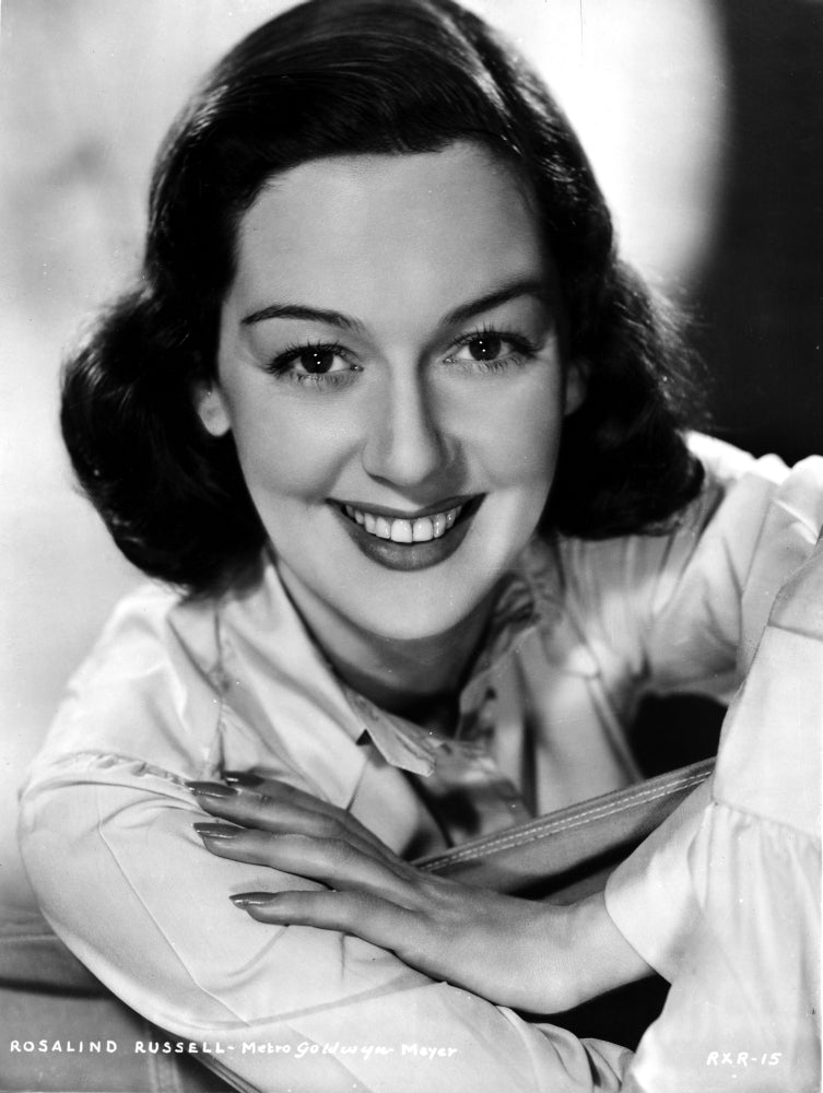 Rosalind Russell smiling in a classic photo print.