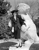 Rosalind Russell Leaning on Statue Photo Print showcasing classic Hollywood elegance.