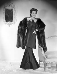 Rosalind Russell photo print posed in dress with hands on waist.