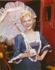 Peggy Castle holding an umbrella in a dotted dress photo print