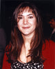 Close-up portrait photo print of Nadia Dajani on a black background.