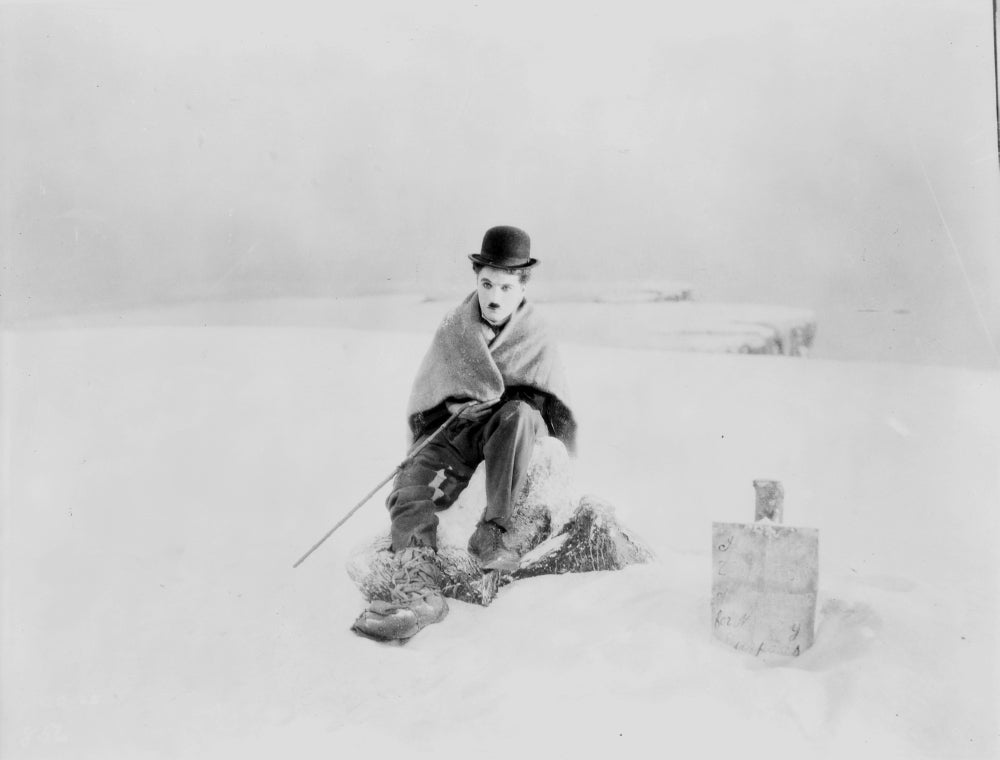 Charlie Chaplin sitting in the snow film still photo print