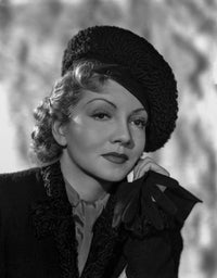 Claudette Colbert posed in a classic black suit photo print.