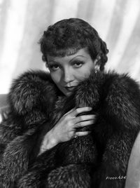 Claudette Colbert in elegant fur dress photo print with white background.