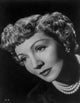 Claudette Colbert looking away photo print on black background