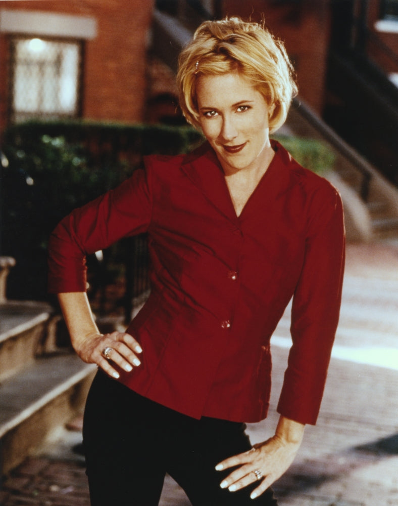 Photo print of Sue Costello posed in a red blouse, showcasing vibrant colors.