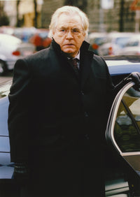 Brian Cox posed in a black coat photo print