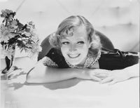 Joan Crawford leaning on a table photo print in vintage style.