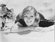 Joan Crawford leaning on a table photo print in vintage style.