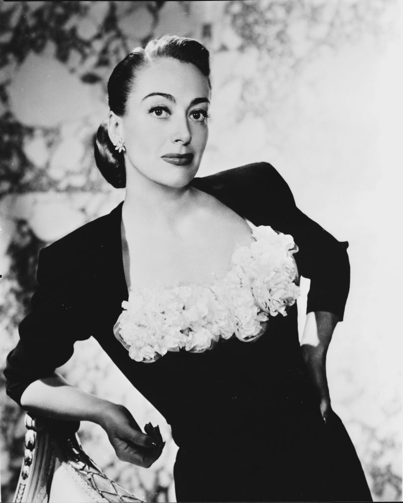 Joan Crawford leaning in a blouse photo print, vintage Hollywood elegance.