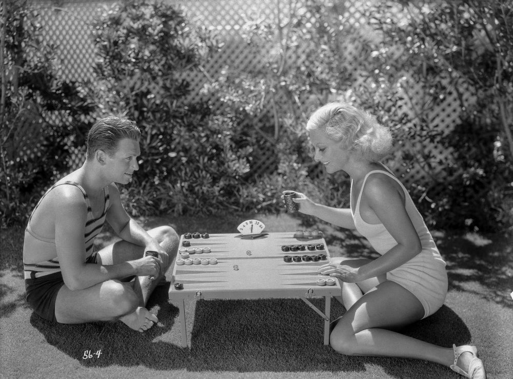 Joan Crawford Playing with a Guy in the Table Photo Print showcasing classic Hollywood charm.