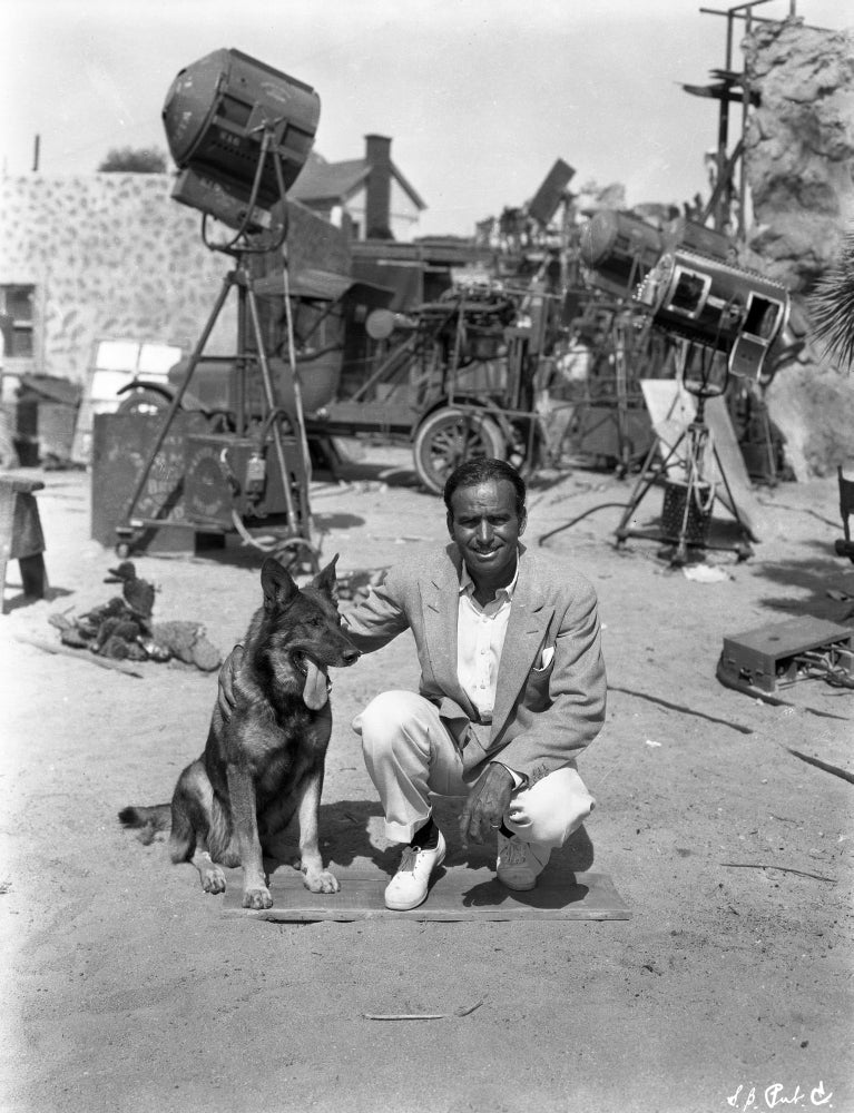 Douglas Fairbanks Jr. on a film set with dog - Photo Print
