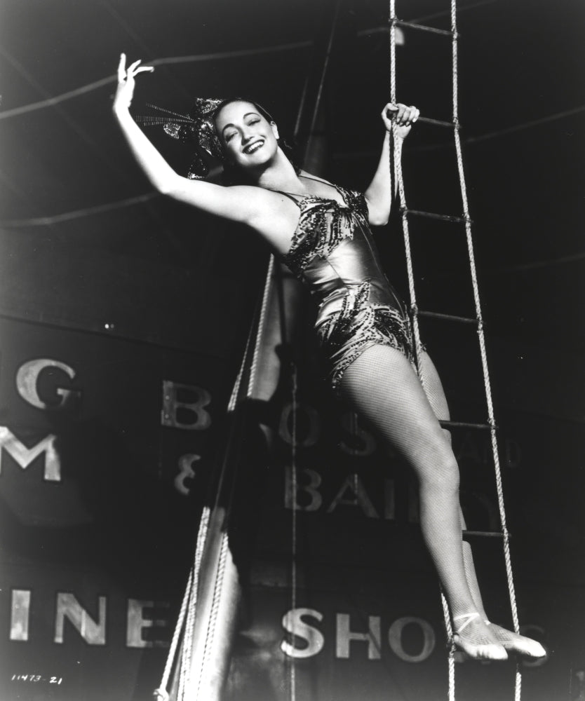 Dorothy Lamour climbing the trapeze in a vintage circus photo print.