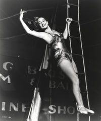 Dorothy Lamour climbing the trapeze in a vintage circus photo print.