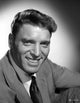 Burt Lancaster wearing a suit in a squat pose photo print