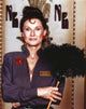 Cloris Leachman posed in blue long sleeve holding a feather duster photo print