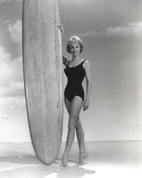 Janet Leigh in a black swimsuit touching a surfing board photo print.