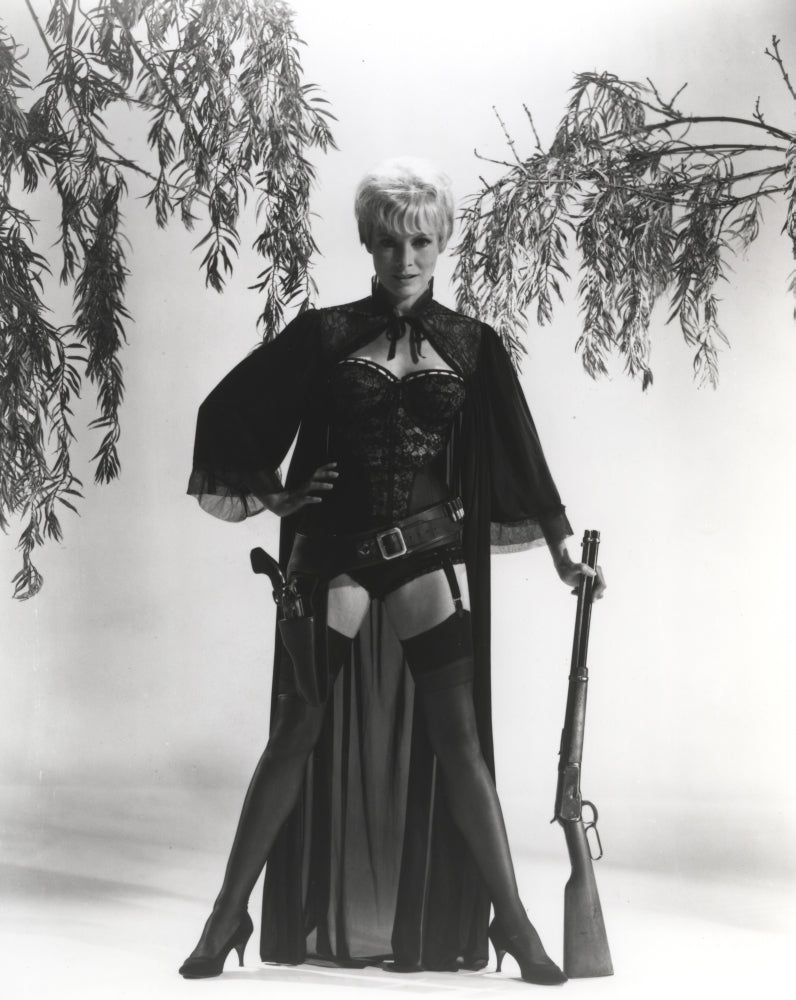 Janet Leigh wearing a corset and holding a rifle photo print.
