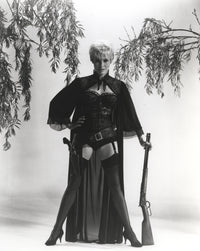 Janet Leigh wearing a corset and holding a rifle photo print.