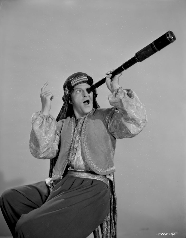 Stanley Clements wearing Arabian costume and using telescope photo print