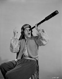 Stanley Clements wearing Arabian costume and using telescope photo print