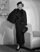 Bette Davis vintage photo print in black lace dress beside a couch.