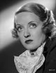 Bette Davis portrait photo print featuring elegant black dress and white linen scarf.