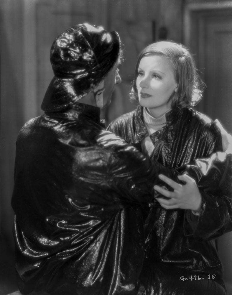 Greta Garbo and a man in a shiny black outfit photo print