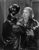 Greta Garbo and a man in a shiny black outfit photo print
