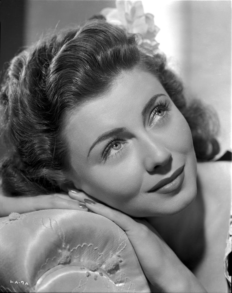 Lenore Aubert leaning on a sofa portrait photo print