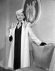 Lenore Aubert in an embroidered coat standing pose photo print