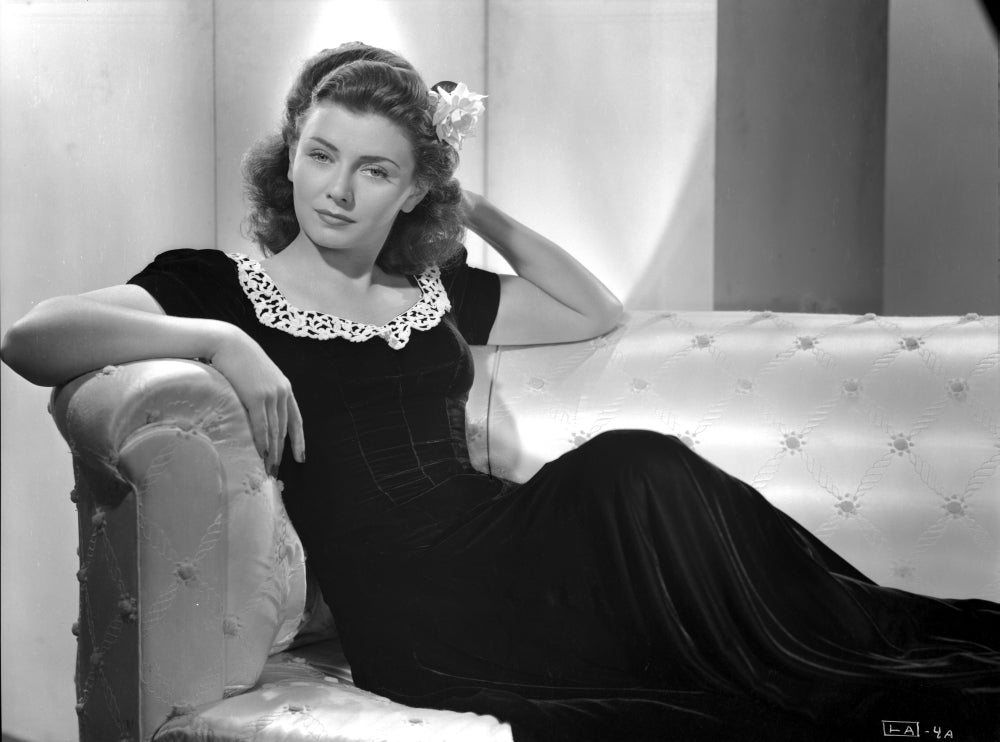 Lenore Aubert Photo Print sitting elegantly on a couch