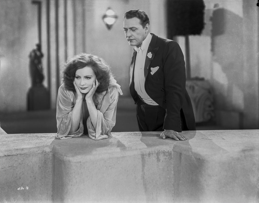 Greta Garbo Leaning While a Man's Talking Photo Print
